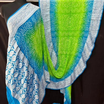 Perrot and light shade of sky Khaddi Georgette rai bandhej saree